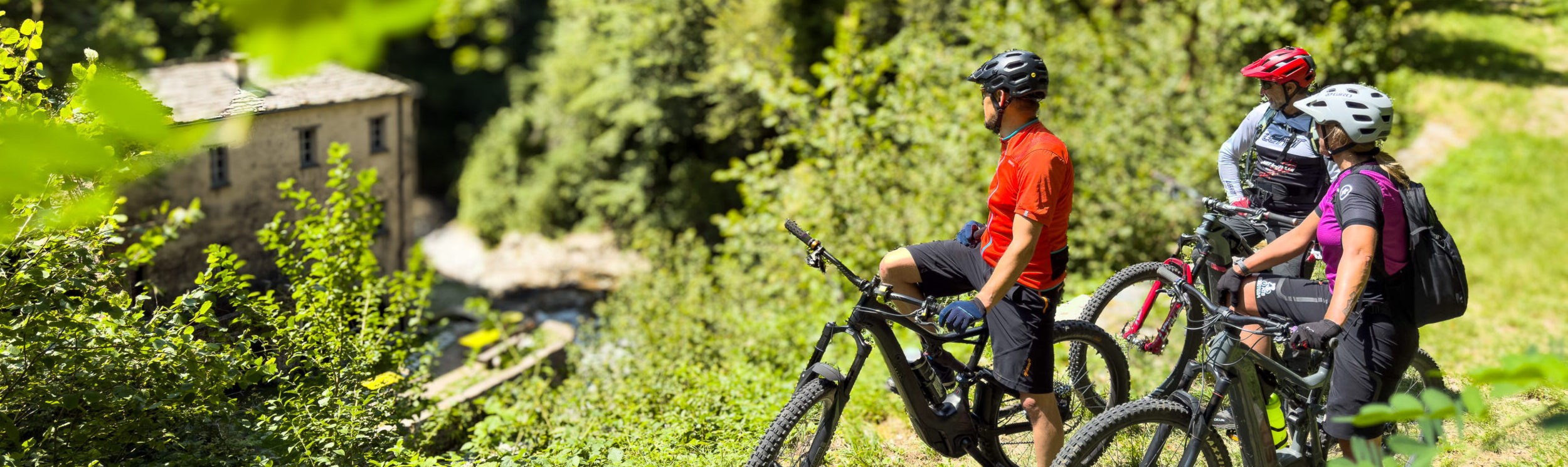 MTB riders visiting the historic Bruzella Mill in Valle di Muggio, South Ticino.